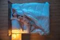 The happy couple lay on the bed. evening night time. view from above Photo