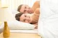 The happy couple lay on the bed Photo