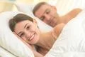 The happy couple lay on the bed Photo