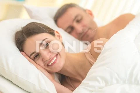 The happy couple lay on the bed Stock Photos