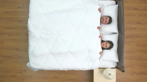 The happy couple lay in the bed. view from above Stock-Footage 75505272