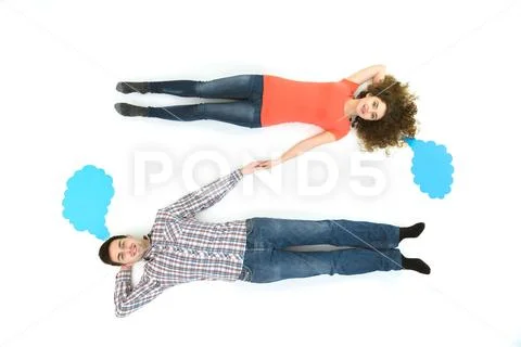 The happy couple lay near the dialog signs. View from above Stock Photos