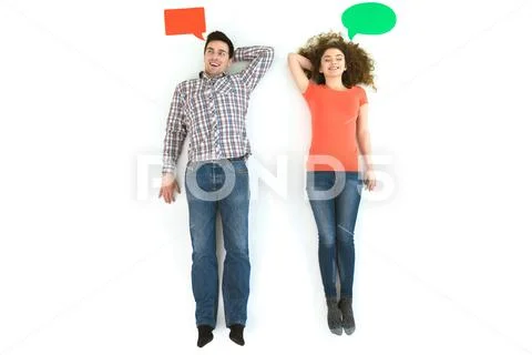 The happy couple lay near the dialog signs. View from above Stock Photos