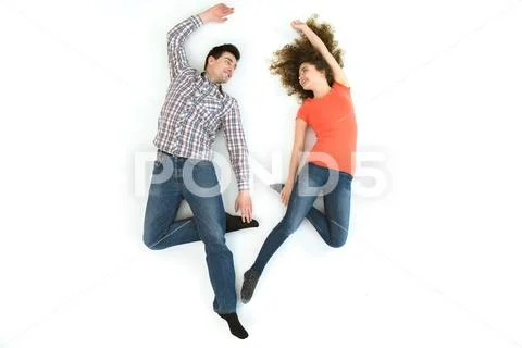 The happy couple lay on the white floor. View from above Stock Photos