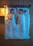 The happy couple lie on the bed. evening night time. view from above Photo