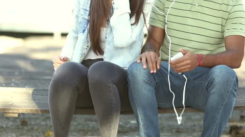 Happy couple listening to music together, sharing earphones Stock Footage 59555616