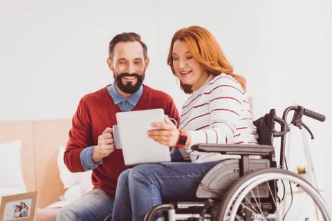 Happy couple looking at screen of tablet 写真素材