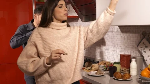 Happy couple in love dancing in kitchen eating having fun Stock Footage 126241243