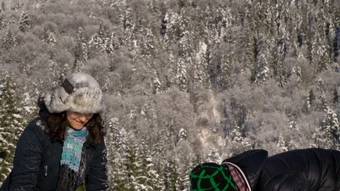 A happy couple of lovers walks through the snow-covered forest. They throw snow Video stock 103710089