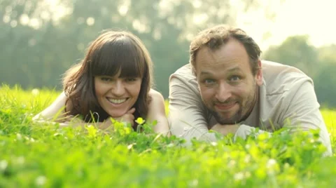 Happy couple lying on a meadow Stock Footage 8579398