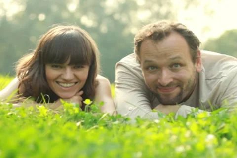 Happy couple lying on a meadow Stock Footage 8579408