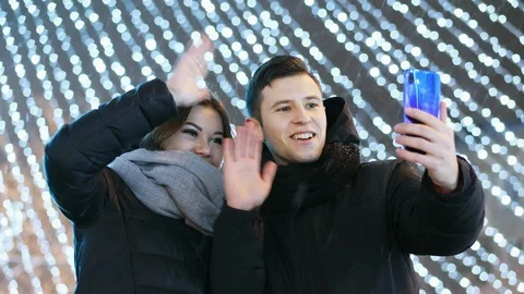 Happy couple making video call to their family on New Year's Night with Video stock 100463752