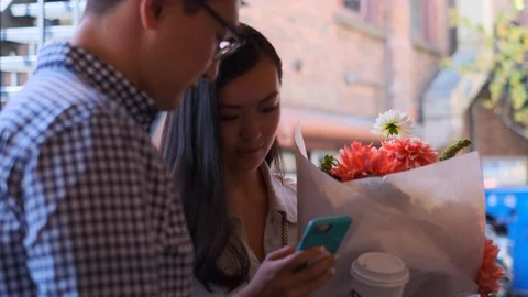 Happy Couple At Market Using Cell Phone 3 Stock Footage 116753844