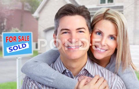 Happy couple near new house. Stock Photos