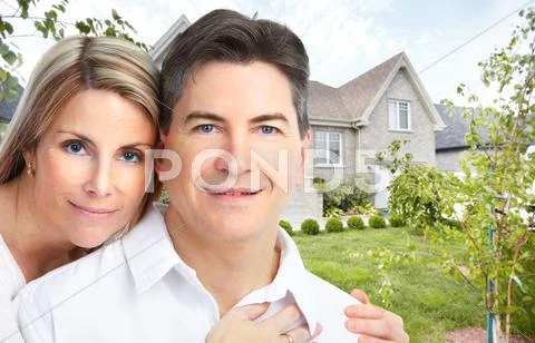 Happy couple near new house. Stock Photos