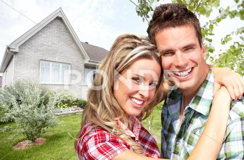 Happy couple near new house. Stock Photos