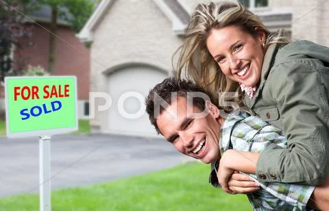 Happy couple near new house. Stock Photos