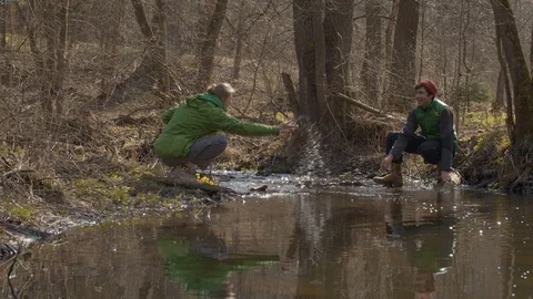 Happy couple on opposite sides of the stream Video stock 129082222