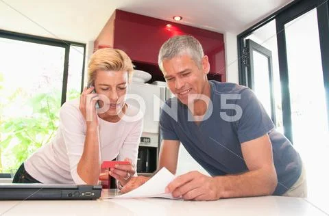 Happy Couple Pay Bills With C Card