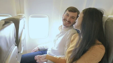 Happy couple in the plane shows a thumbs up Stock Footage