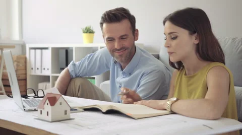 Happy couple planning their future home design Stock Footage 64652409