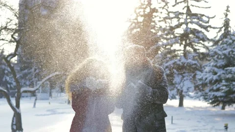 A happy couple playfully spends time in a winter park having fun on a snowy Stock Footage 162099800