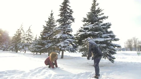 A happy couple playfully spends time in a winter park having fun on a snowy Stock Footage 162665934