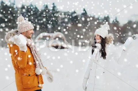 Happy couple playing snowballs in winter Stock Photos