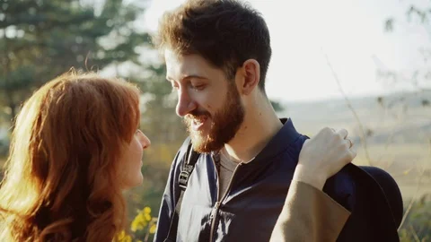 Happy couple posing in embraces at camera in spring, sunny park Video stock 104474164