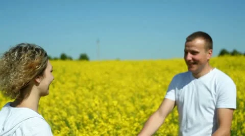 Happy couple on rape field 스톡 동영상 11108911