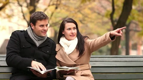 Happy couple reading city map Stock Footage 9783425