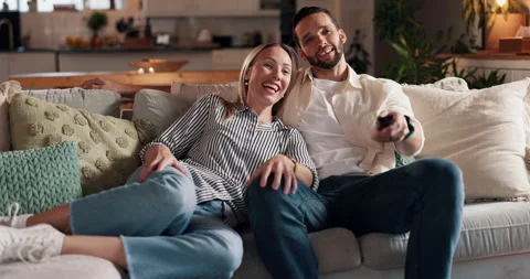 Happy couple, relax and watching tv on sofa for movie, show or streaming Stock Footage 308225383