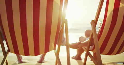 Happy Couple Relaxing Watching the Sunset on Vacation Stock Footage
