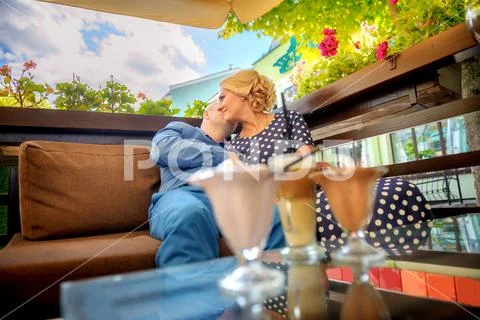 Happy couple resting in street coffee, hugging and kissing, on the table stan Stock Photos