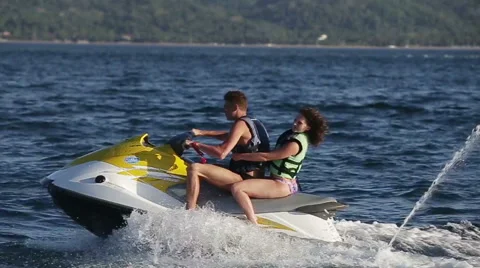 Happy couple riding jet ski Stock Footage 59537533