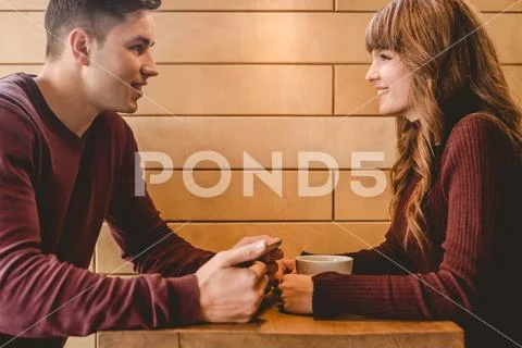 The happy couple sitting at the restaurant table Stock Photos