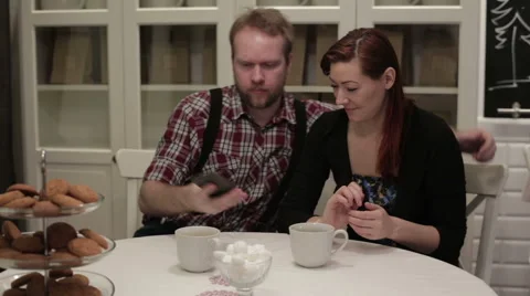 Happy couple sitting at the table doing selfie Stock Footage 62799664