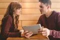 The happy couple sitting with a tablet at the restaurant table Photo