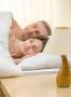 The happy couple sleeping on the bed on the background of a bedside lamp Photo