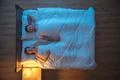 The happy couple sleeping on the bed. night time. view from above Photo