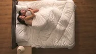 The Happy Couple Sleeping In The Bed. View From Above Stock Footage