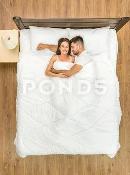 The happy couple sleeping on the bed. View from above Stock Photos