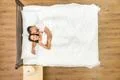 The happy couple sleeping on the bed. View from above Photo