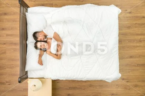 The happy couple sleeping on the bed. View from above Stock Photos
