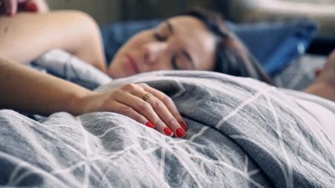 Happy couple sleeping in a comfortable bed at home Stock-Footage 102579178