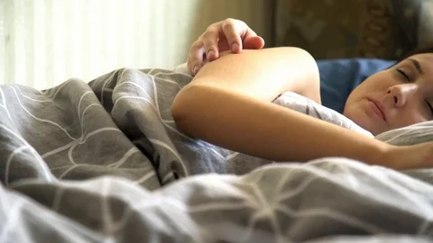 Happy couple sleeping in a comfortable bed at home Stock Footage 102579185