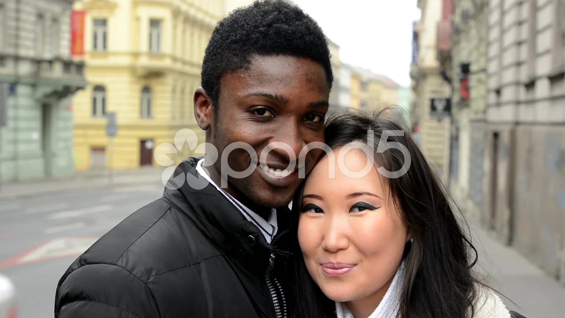 Happy couple smile to camera - black man and asian woman