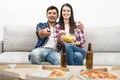 The happy couple on the sofa watching television on the white wall background Photo