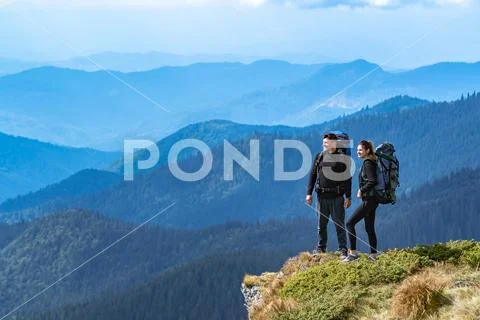 The happy couple standing on the cliff Stock Photos