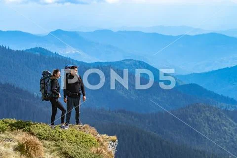 The happy couple standing on the cliff Stock Photos